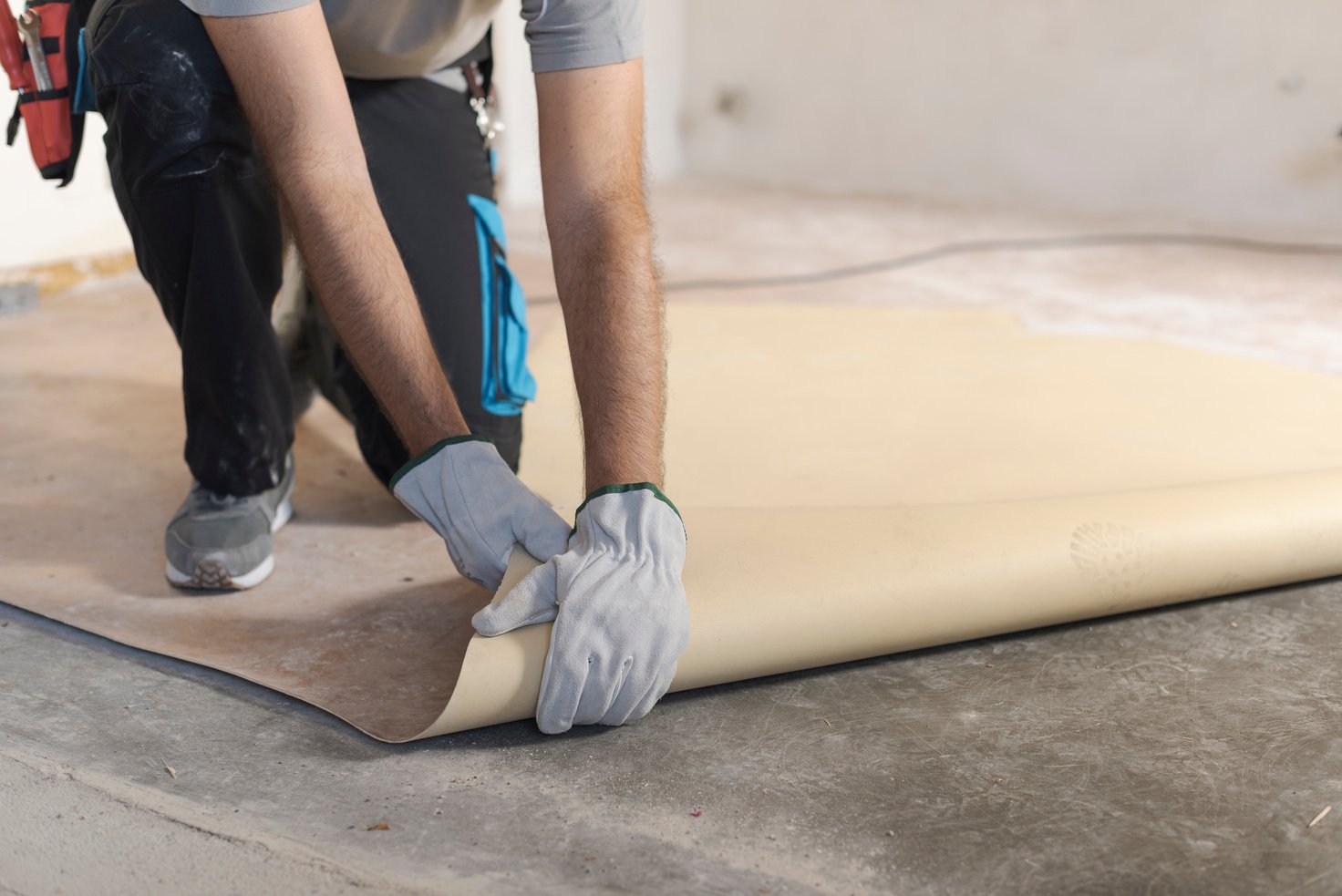 Contractor removing an old linoleum flooring